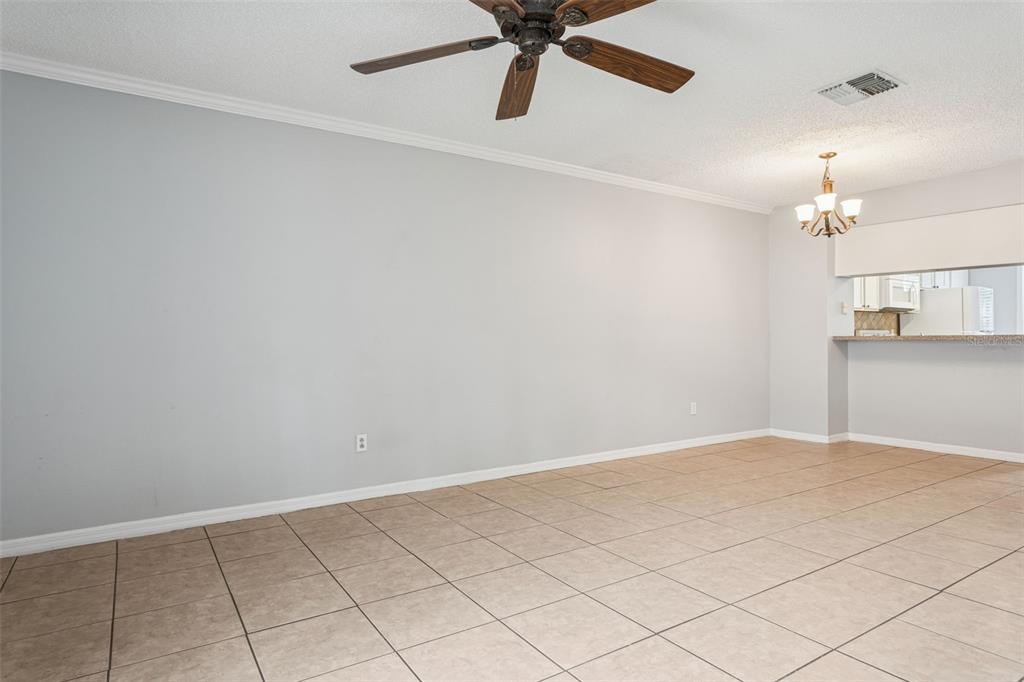 11356 Stratton Park Drive Temple Terrace, FL 33617 - Photo 12 of 25 an empty room with chandelier fan and windows