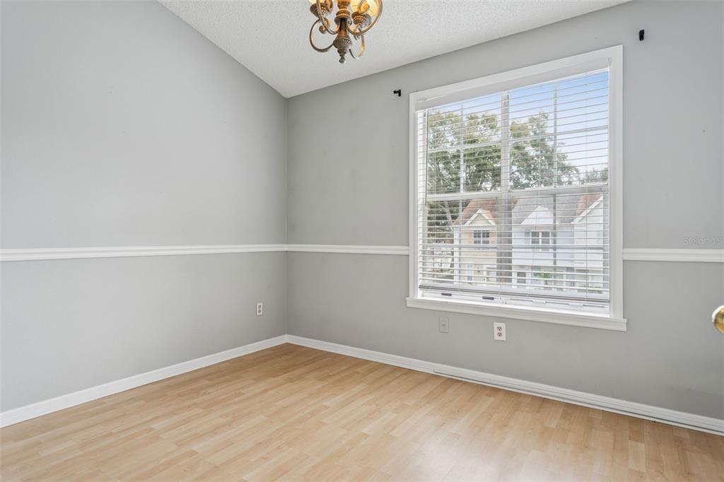 11356 Stratton Park Drive Temple Terrace, FL 33617 - Photo 14 of 25 a view of an empty room with wooden floor and a window