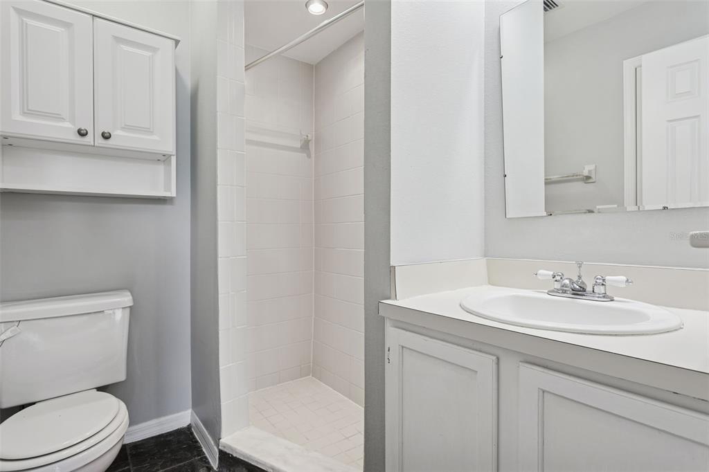 11356 Stratton Park Drive Temple Terrace, FL 33617 - Photo 16 of 25 a bathroom with a toilet sink vanity and mirror