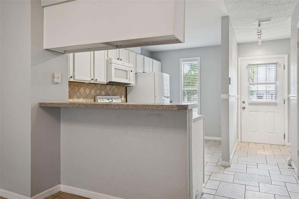 11356 Stratton Park Drive Temple Terrace, FL 33617 - Photo 5 of 25 a kitchen with stainless steel appliances a sink and a refrigerator