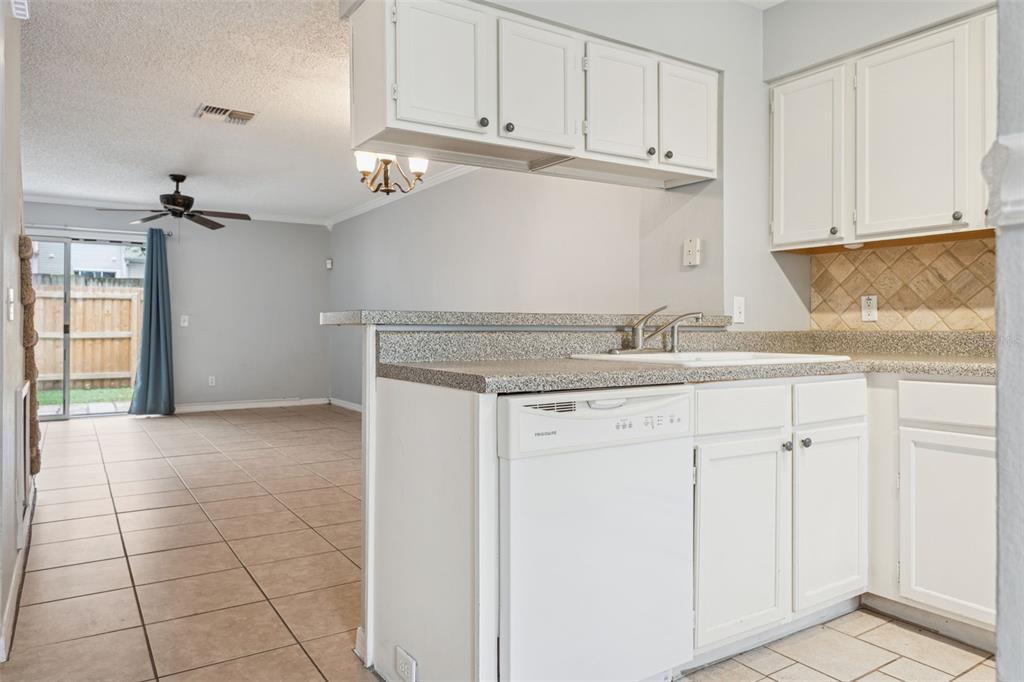 11356 Stratton Park Drive Temple Terrace, FL 33617 - Photo 7 of 25 a kitchen with granite countertop white cabinets and stainless steel appliances
