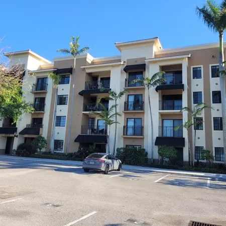 front view of a brick house with a small yard