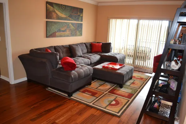 a kitchen with stainless steel appliances granite countertop a refrigerator stove a sink and dishwasher with wooden floor