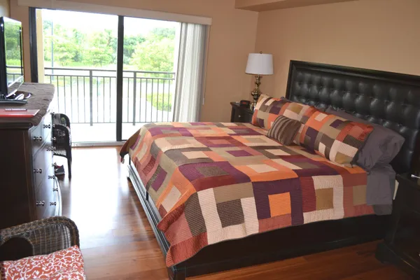 a bathroom with a granite countertop sink a toilet and a mirror