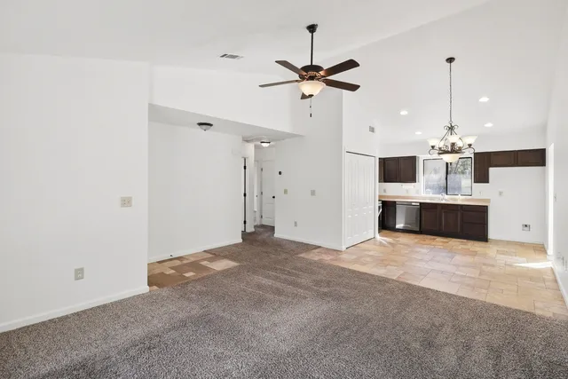a view of a kitchen with a sink and a ceiling fan