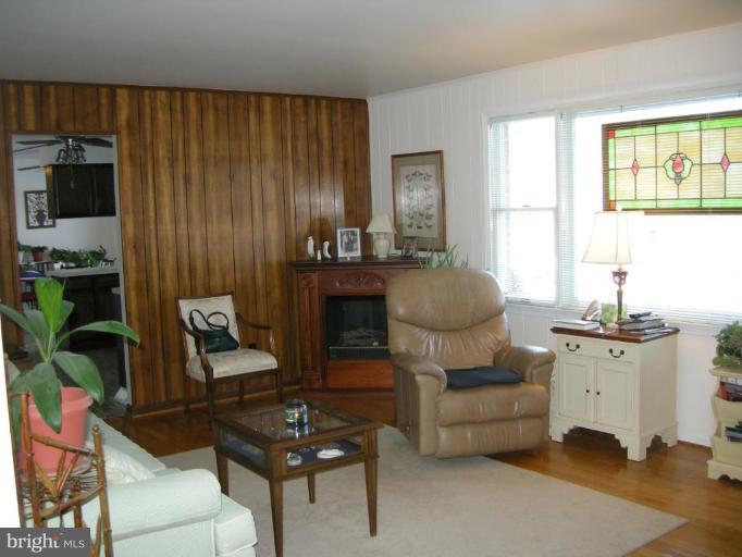 13221 Falls Road Cockeysville, MD 21030 - Photo 11 of 12 a living room with furniture and a fireplace