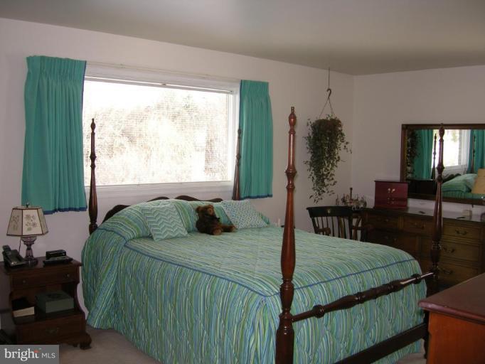 13221 Falls Road Cockeysville, MD 21030 - Photo 3 of 12 a bedroom with a bed and a window