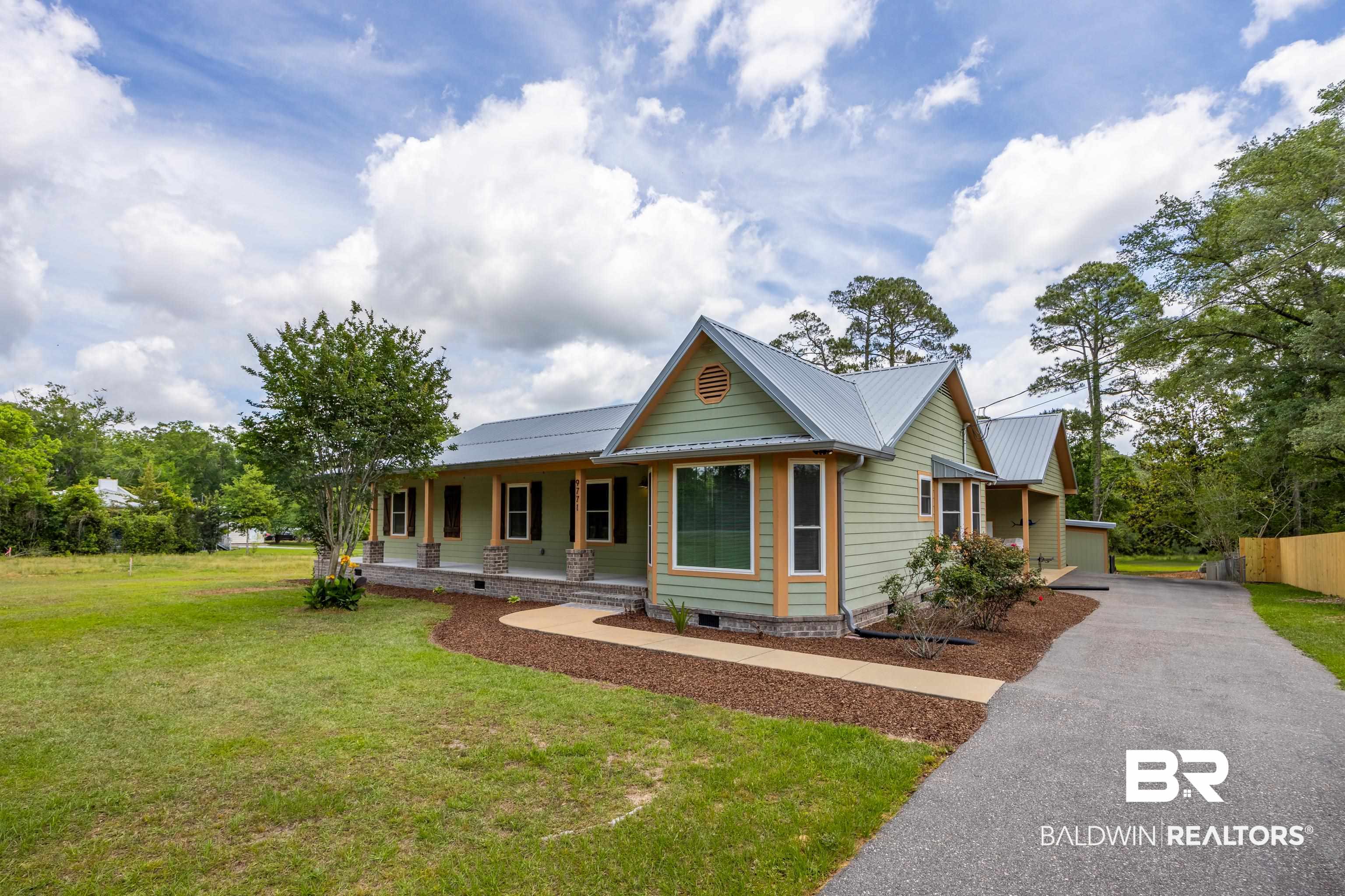 9771 Clarke Ridge Road Foley, AL 36535 - Photo 4 of 72 View of front facade with sidewalk to covered porch.