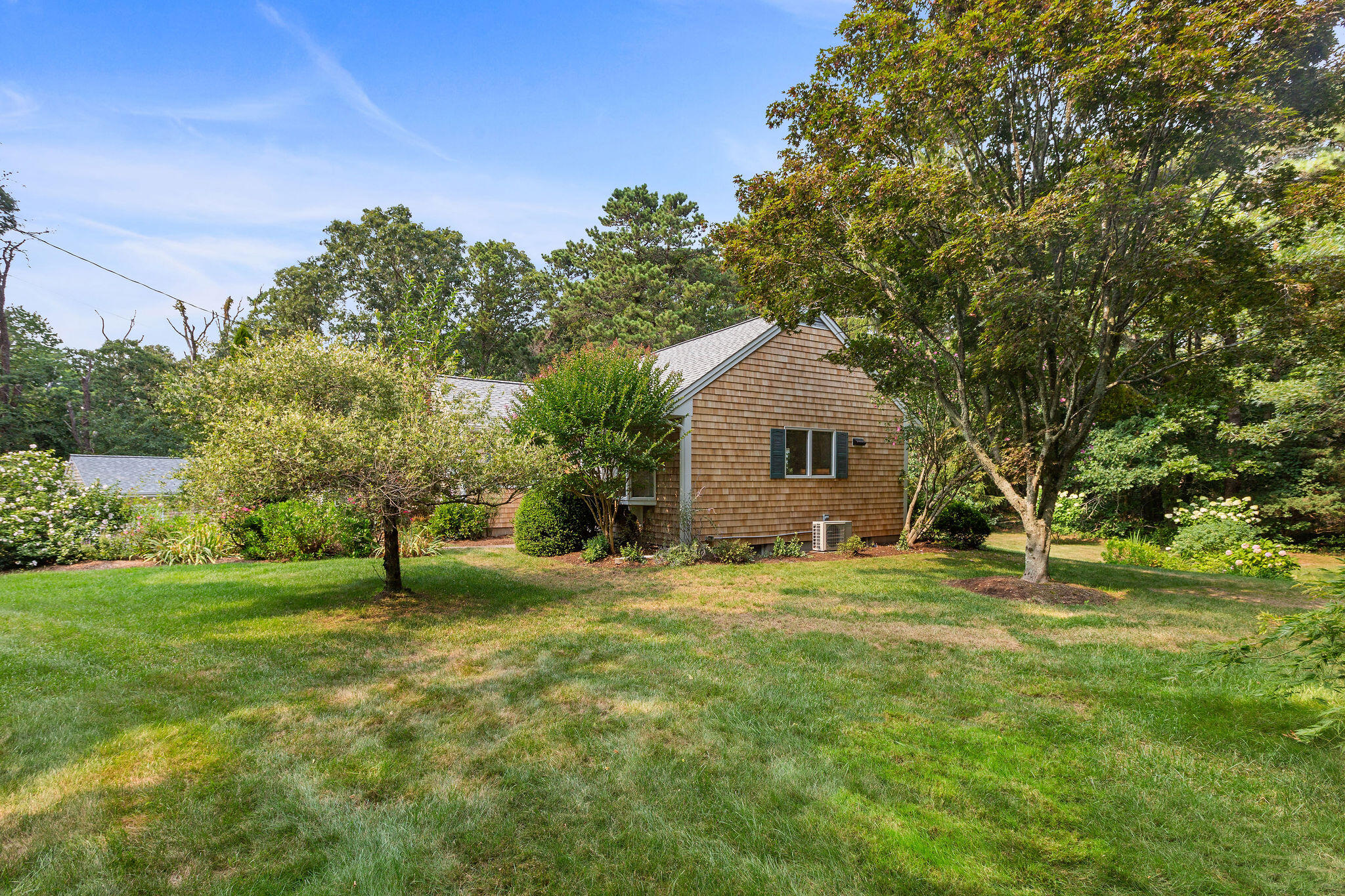 75 Monument Road Orleans, MA 02653 - Photo 11 of 61 a front view of a house with a yard