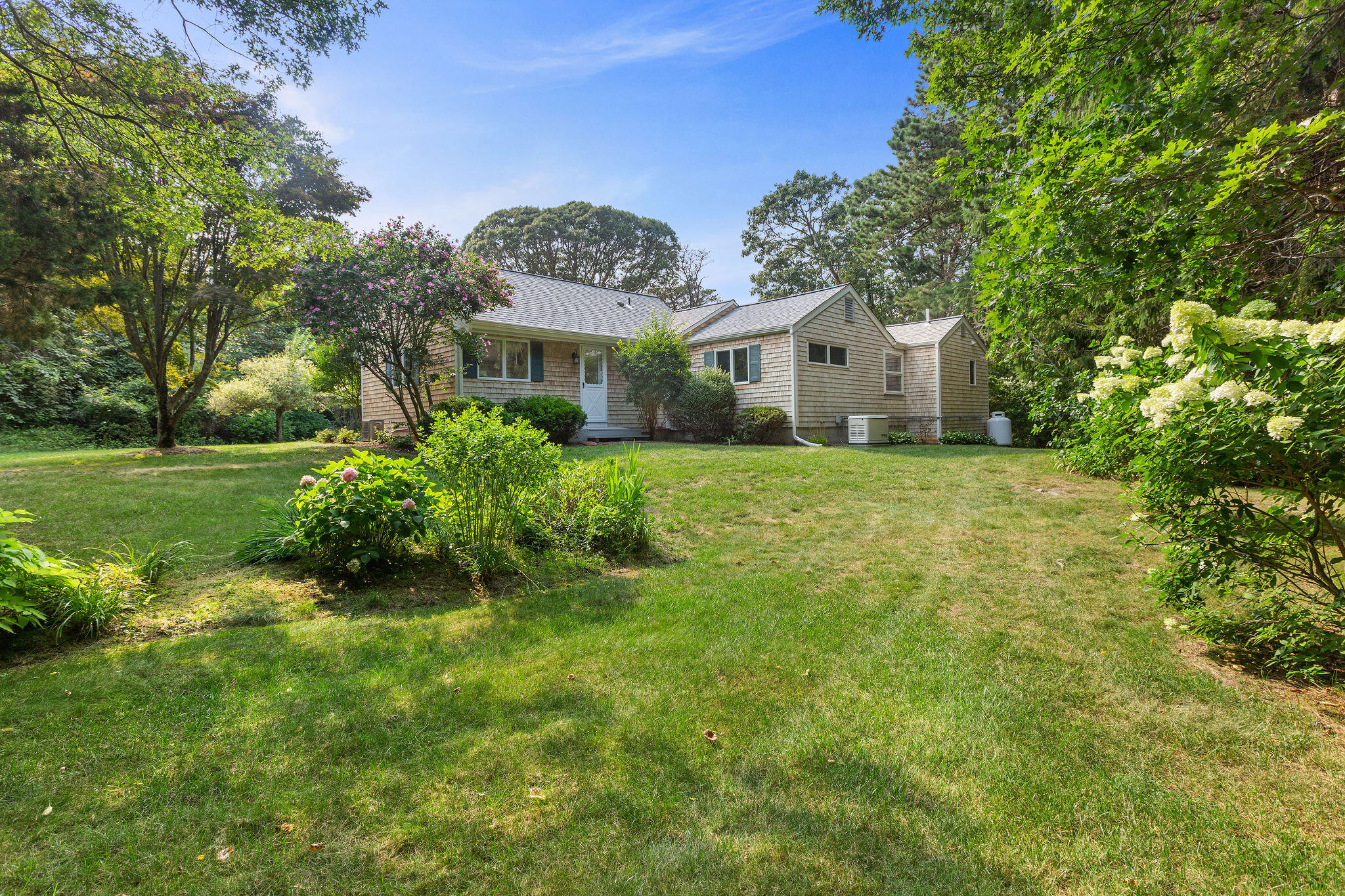 75 Monument Road Orleans, MA 02653 - Photo 13 of 61 a front view of a house with a garden