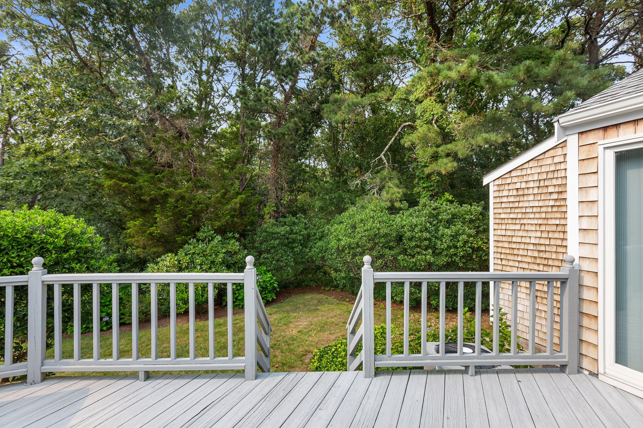 75 Monument Road Orleans, MA 02653 - Photo 20 of 61 a view of backyard with deck and wooden floor
