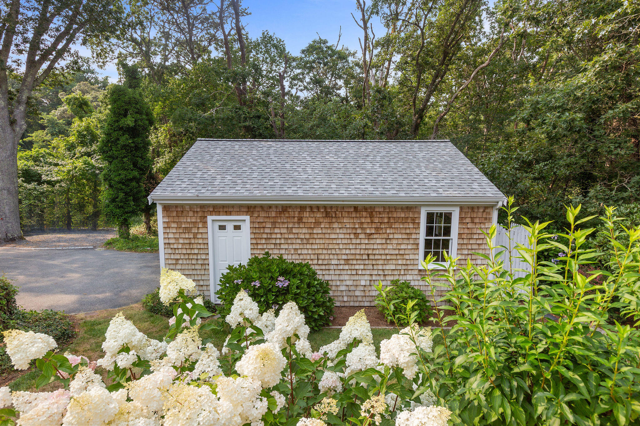75 Monument Road Orleans, MA 02653 - Photo 23 of 61 a aerial view of a house with a yard and potted plants