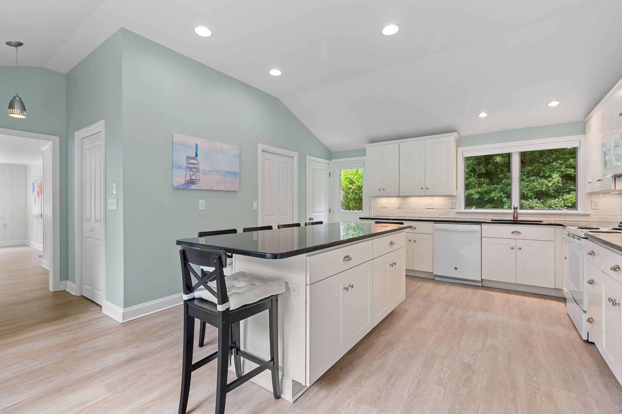 75 Monument Road Orleans, MA 02653 - Photo 31 of 61 a kitchen with a table chairs refrigerator and window