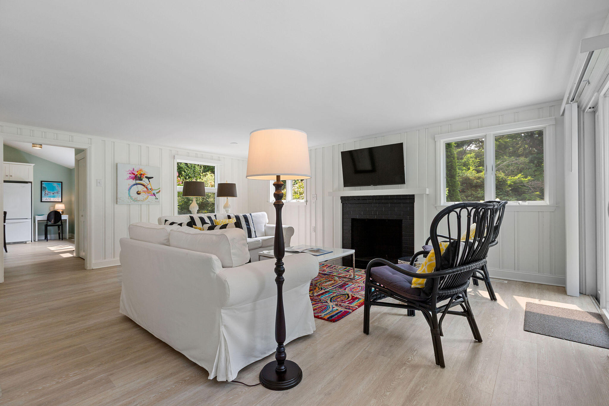 75 Monument Road Orleans, MA 02653 - Photo 40 of 61 a living room with furniture a fireplace and a flat screen tv