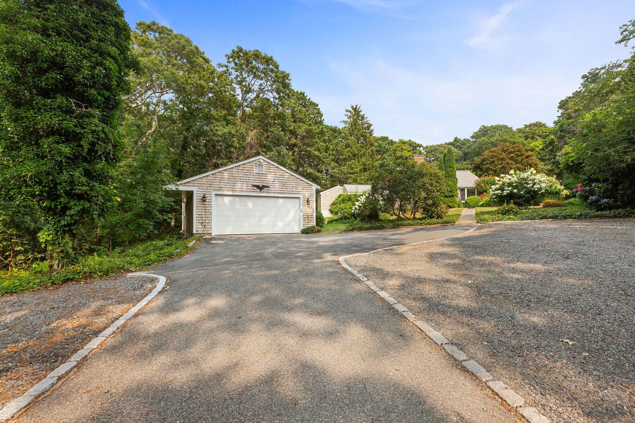 75 Monument Road Orleans, MA 02653 - Photo 4 of 61 a front view of a house with a yard and garage