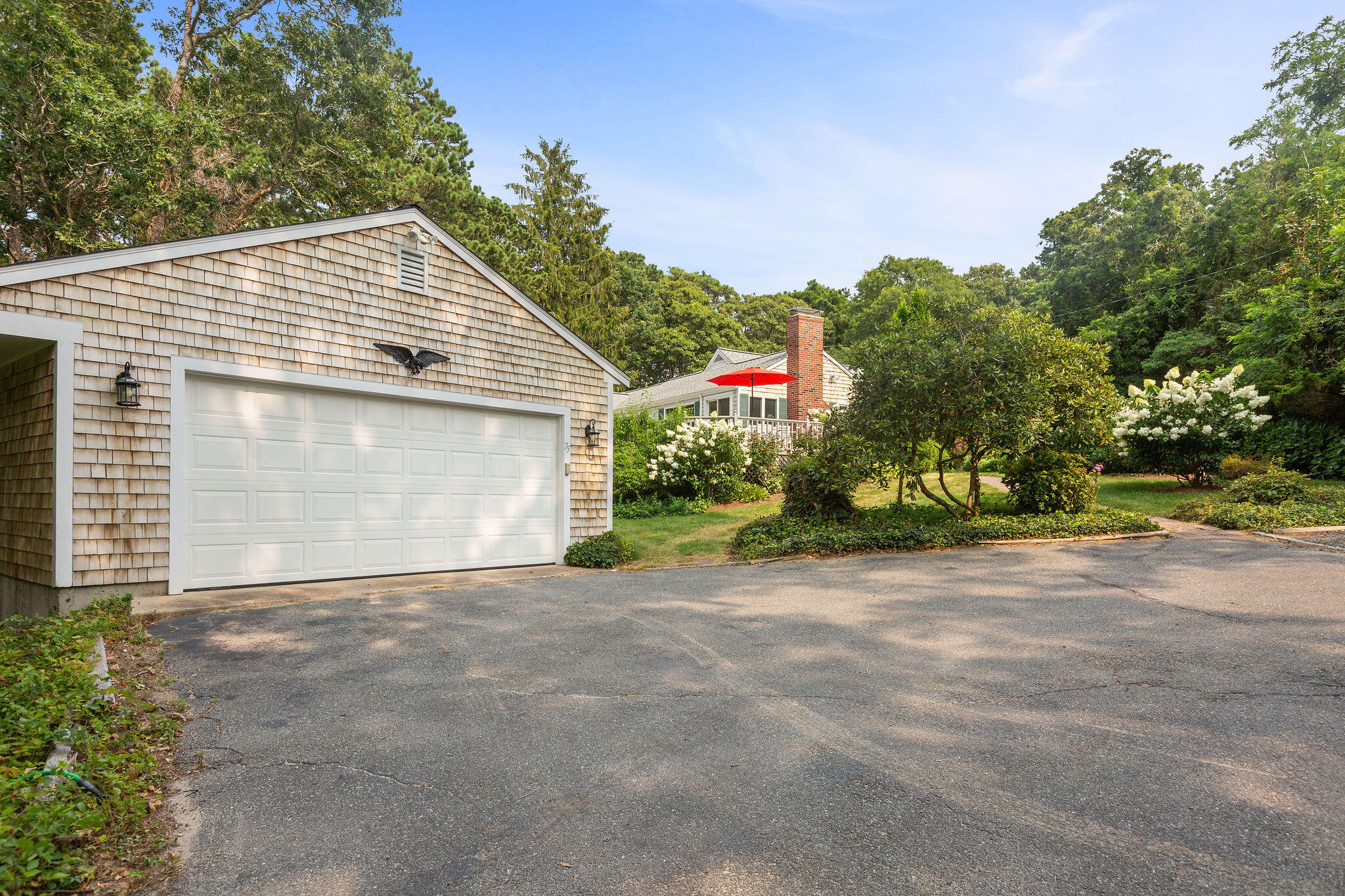 75 Monument Road Orleans, MA 02653 - Photo 5 of 61 a view of a house with a yard and garage