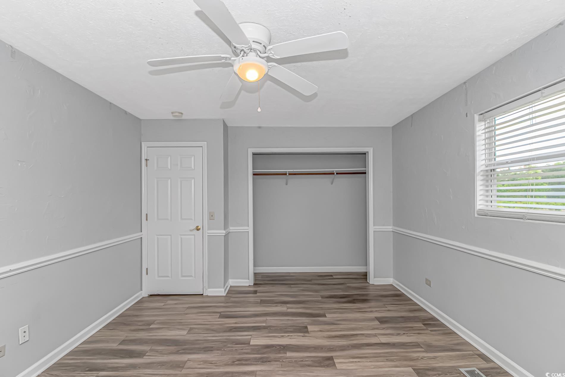 2829 Highway 129 Galivants Ferry, SC 29544 - Photo 16 of 40 Unfurnished bedroom with wood finished floors, a closet, ceiling fan, and a textured ceiling