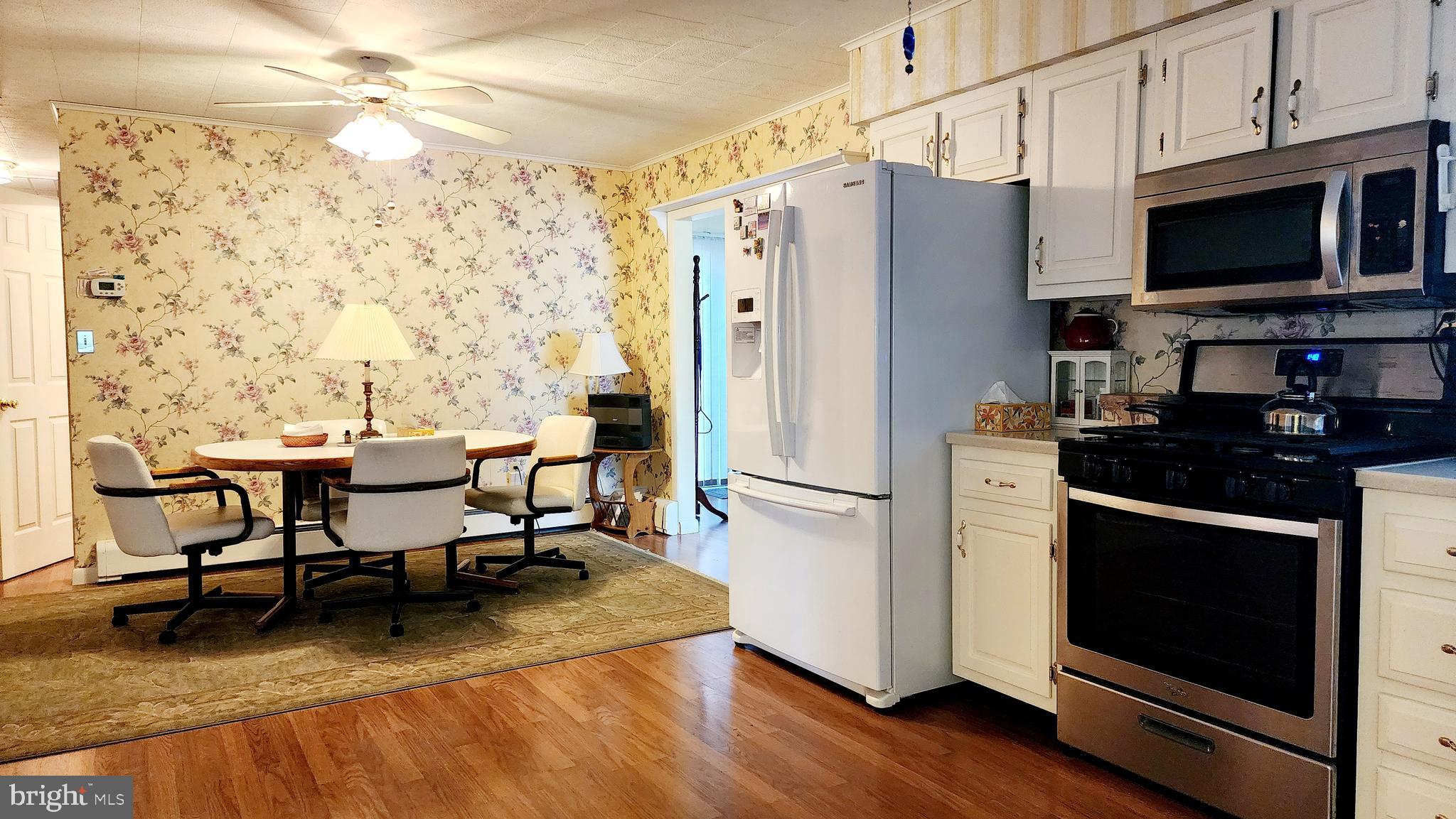 140 Water Street Fairfield, PA 17320 - Photo 11 of 40 a kitchen with stainless steel appliances a refrigerator stove microwave and dining table