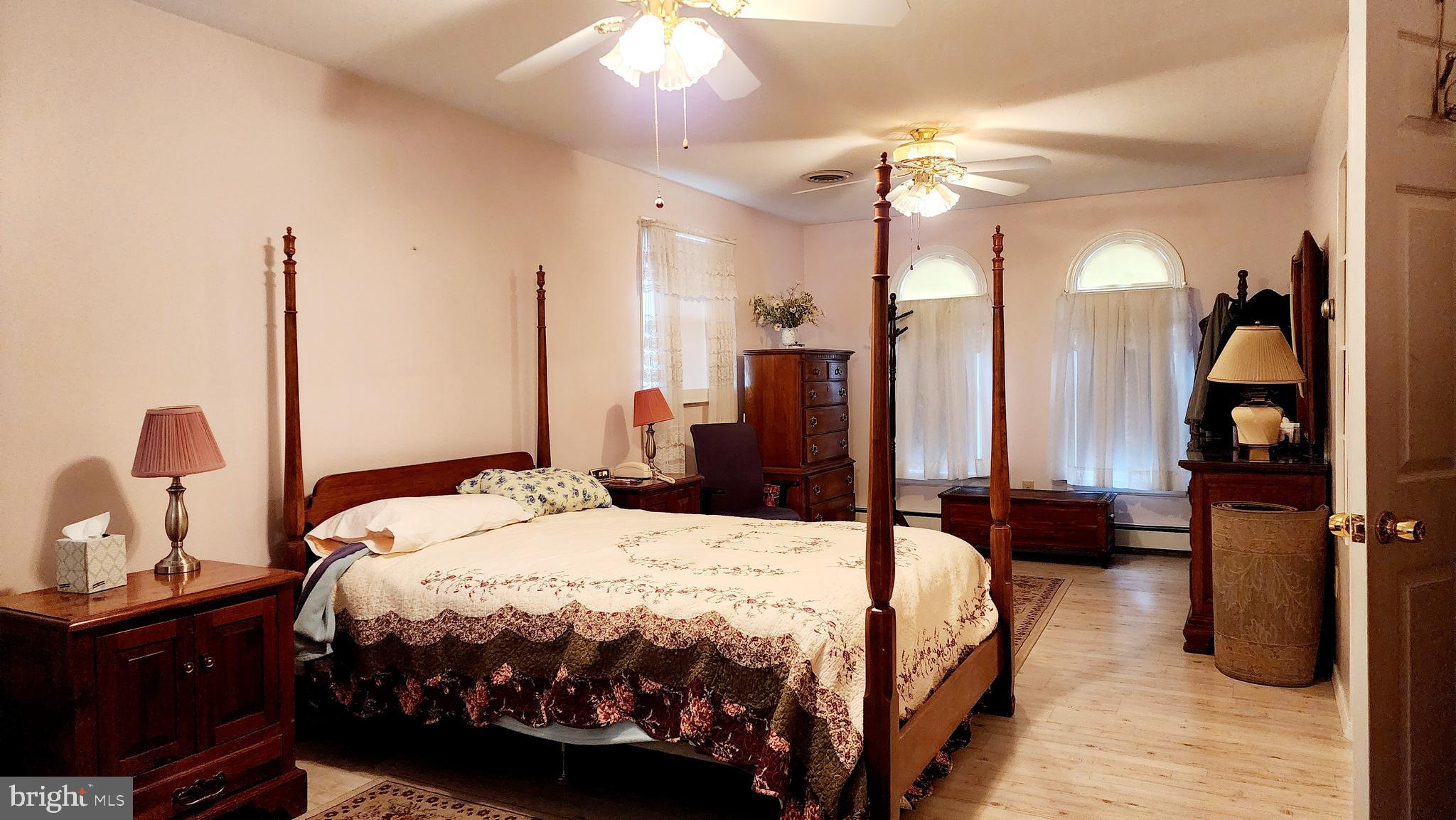 140 Water Street Fairfield, PA 17320 - Photo 13 of 40 a bedroom with a bed and a chandelier