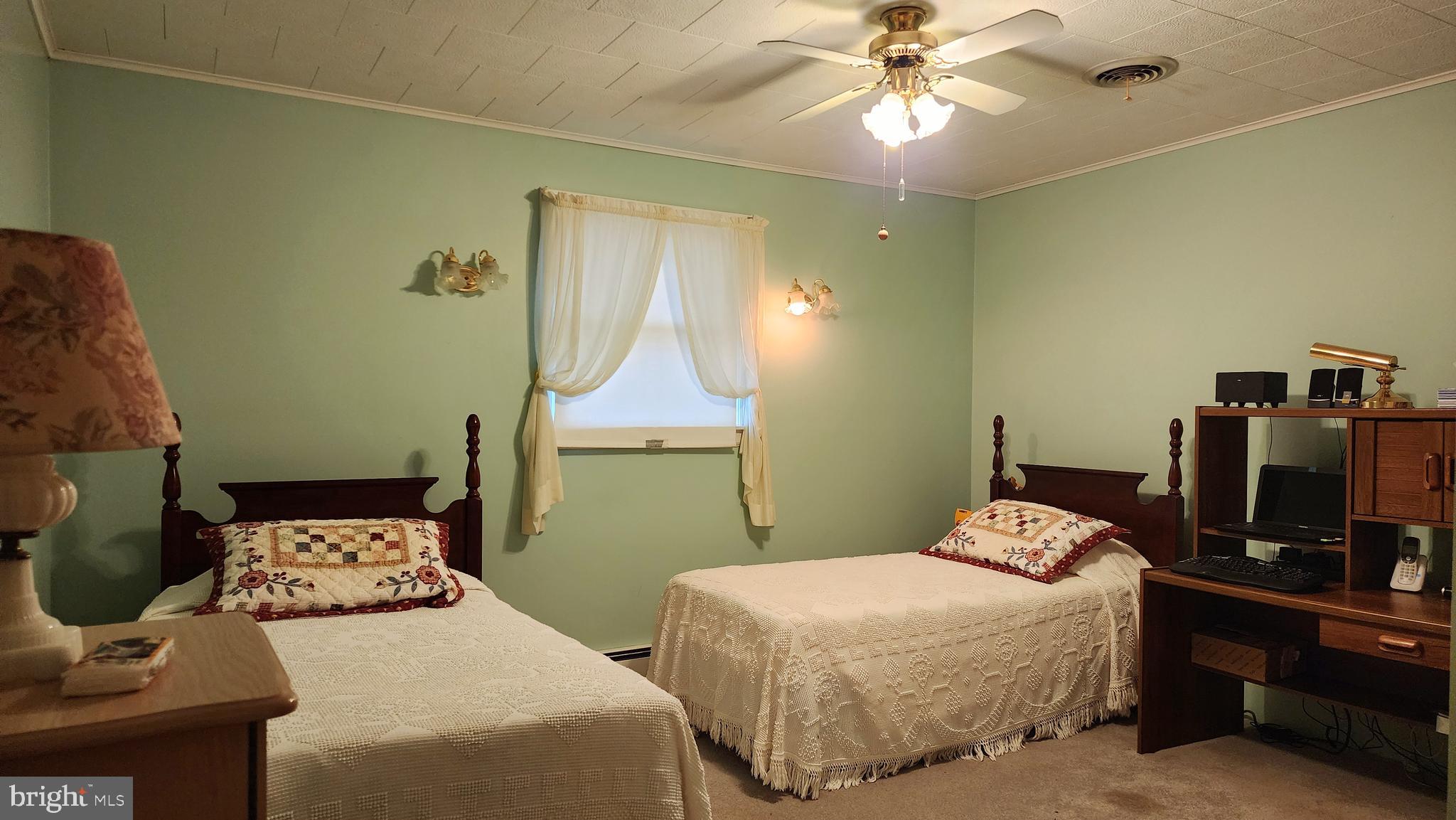 140 Water Street Fairfield, PA 17320 - Photo 16 of 40 a bedroom with two beds and a chandelier