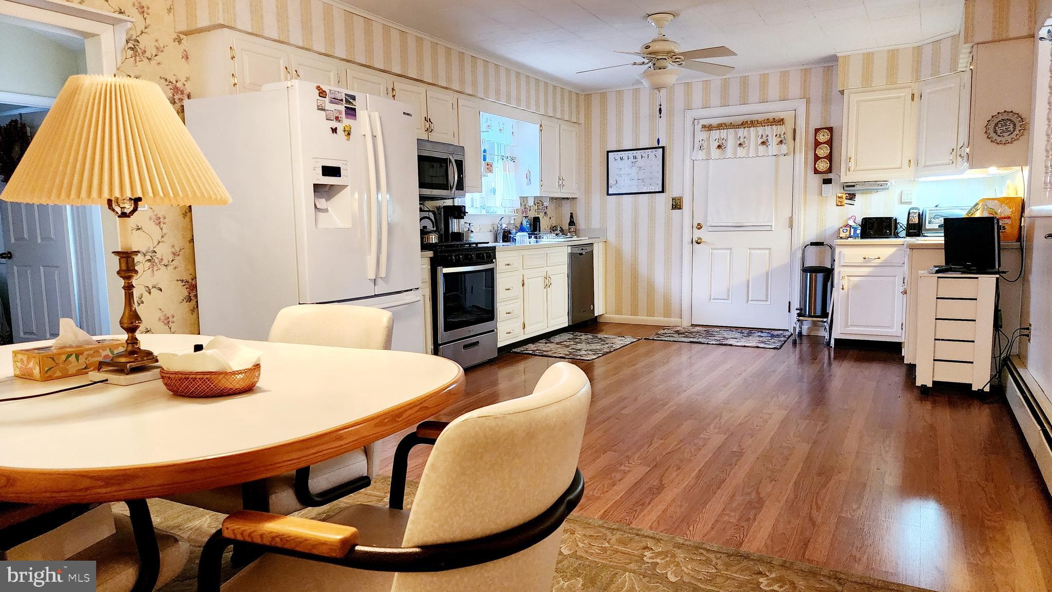 140 Water Street Fairfield, PA 17320 - Photo 7 of 40 a kitchen with stainless steel appliances a dining table chairs and refrigerator