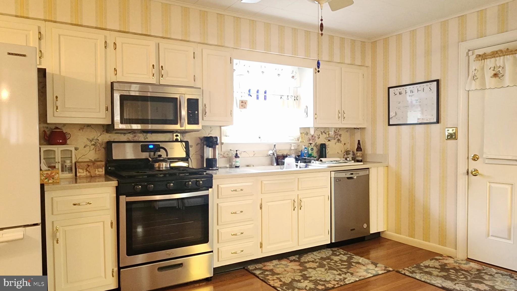 140 Water Street Fairfield, PA 17320 - Photo 10 of 40 a kitchen with stainless steel appliances granite countertop a stove a sink and a refrigerator