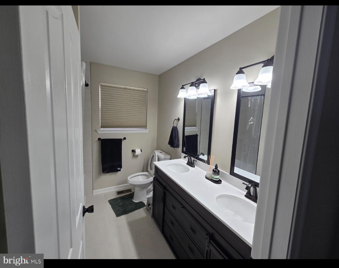 361 Rainey Road Swedesboro, NJ 08085 - Photo 17 of 17 a bathroom with a sink vanity granite and a mirror