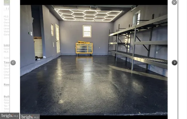 a view of water heater room with wooden floor