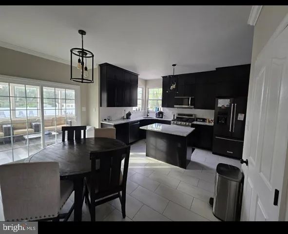 a dining room with furniture and a flat screen tv