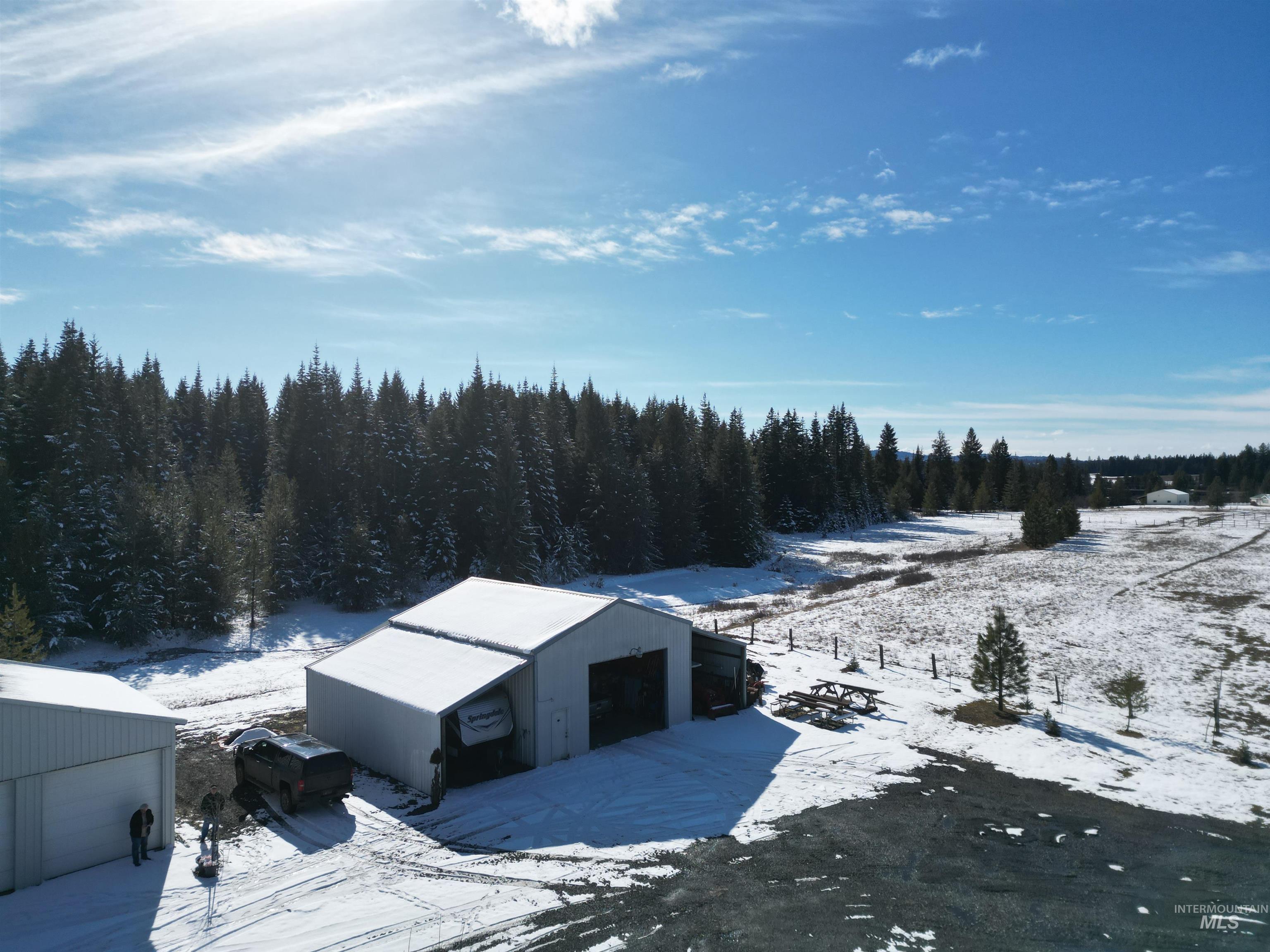 254 Lackey Road Weippe, ID 83553 - Photo 15 of 37 Snowy aerial view featuring a wooded view