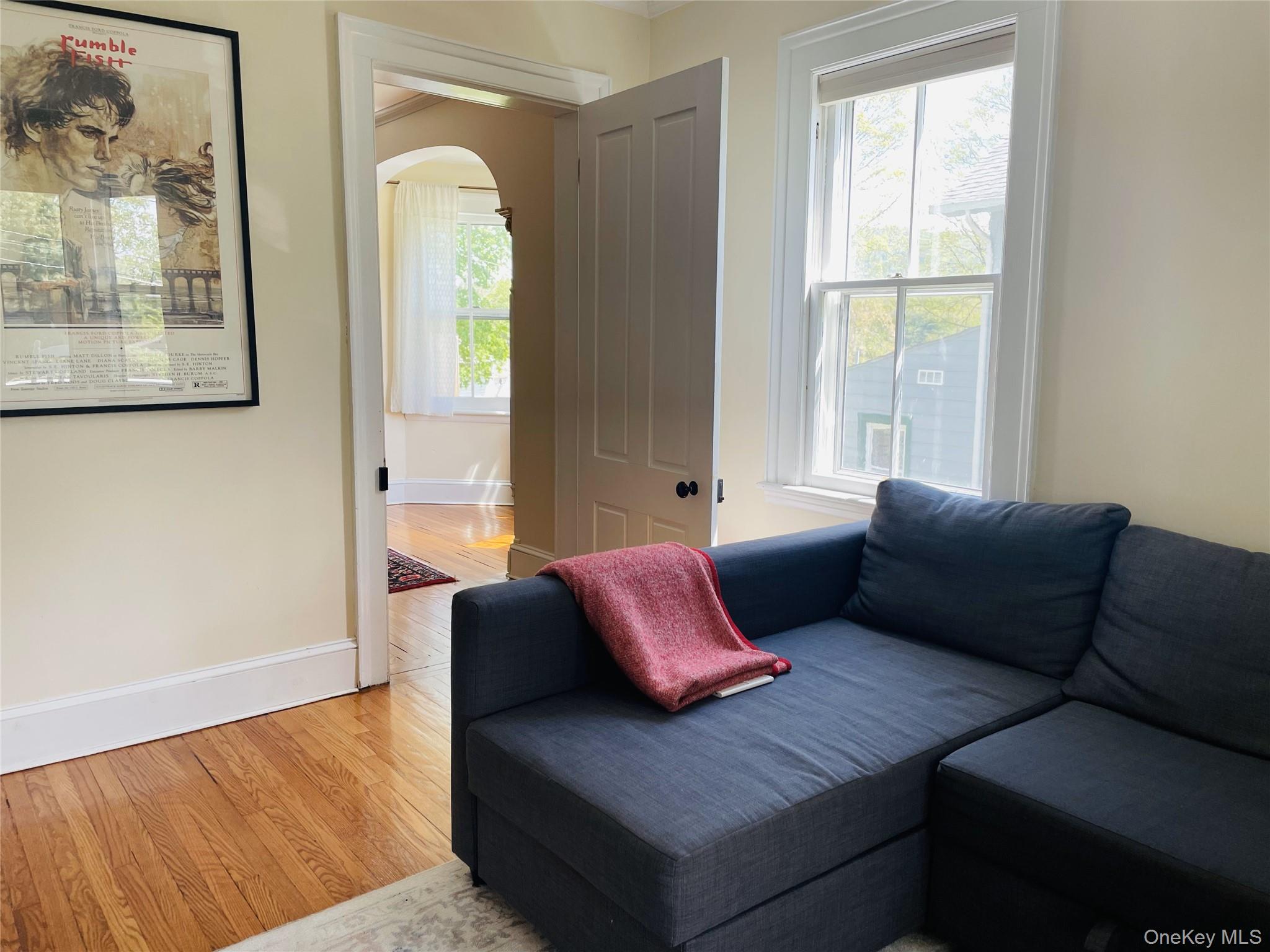 12 Parrott Street Cold Spring, NY 10516 - Photo 9 of 18 Living area featuring baseboards, arched walkways, and light wood finished floors