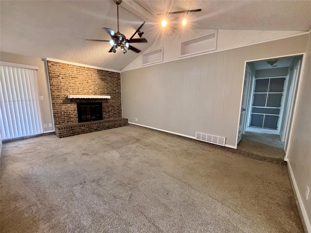 337 Apache Trail Keller, TX 76248 - Photo 5 of 16 an empty room with a fireplace and windows
