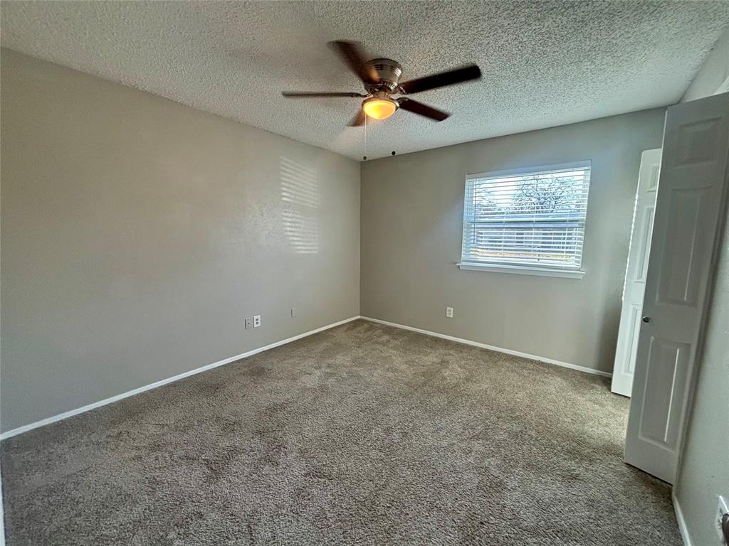 337 Apache Trail Keller, TX 76248 - Photo 10 of 16 an empty room with ceiling fan and window