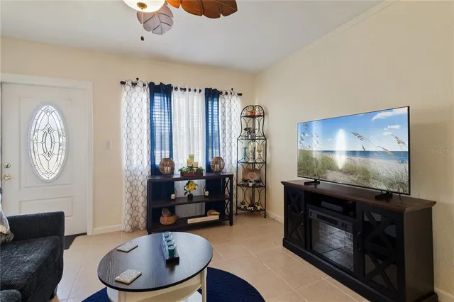 a living room with furniture a large window and a flat screen tv