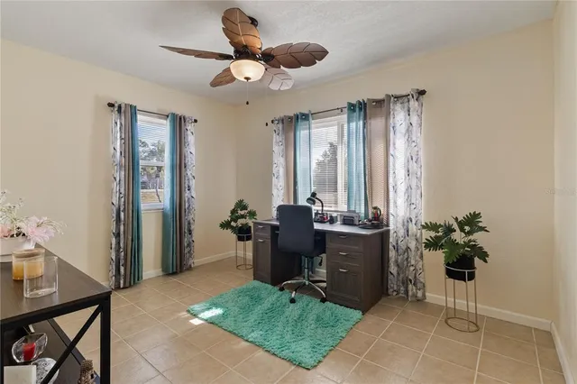 a view of a bedroom with furniture and ceiling fan