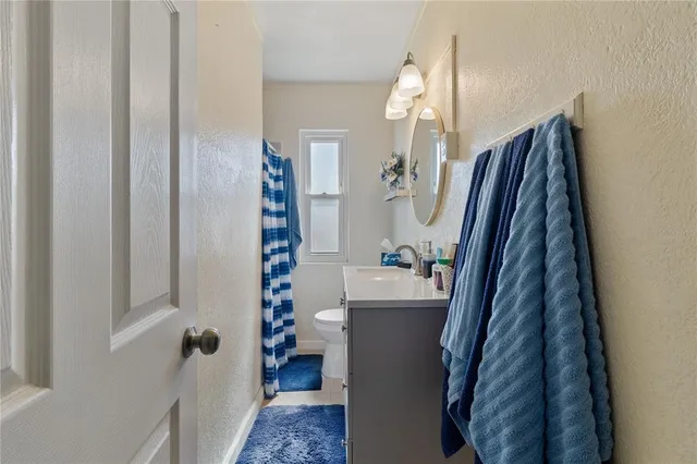 a bedroom with a bed and a dresser in it