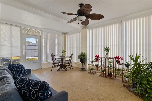 a living room with furniture a rug and a window