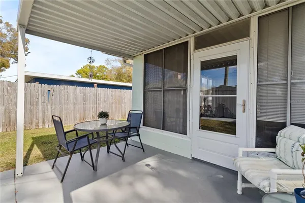 a view of a porch with furniture and a gate