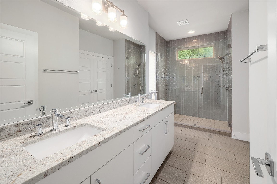 1205 Elm Street, Unit 8 Austin, TX 78703 - Photo 16 of 26 Primary full bathroom featuring double vanity and walk-in shower.