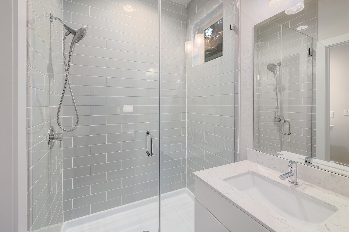 1205 Elm Street, Unit 8 Austin, TX 78703 - Photo 21 of 26 Full bathroom with vanity and a walk-in shower.
