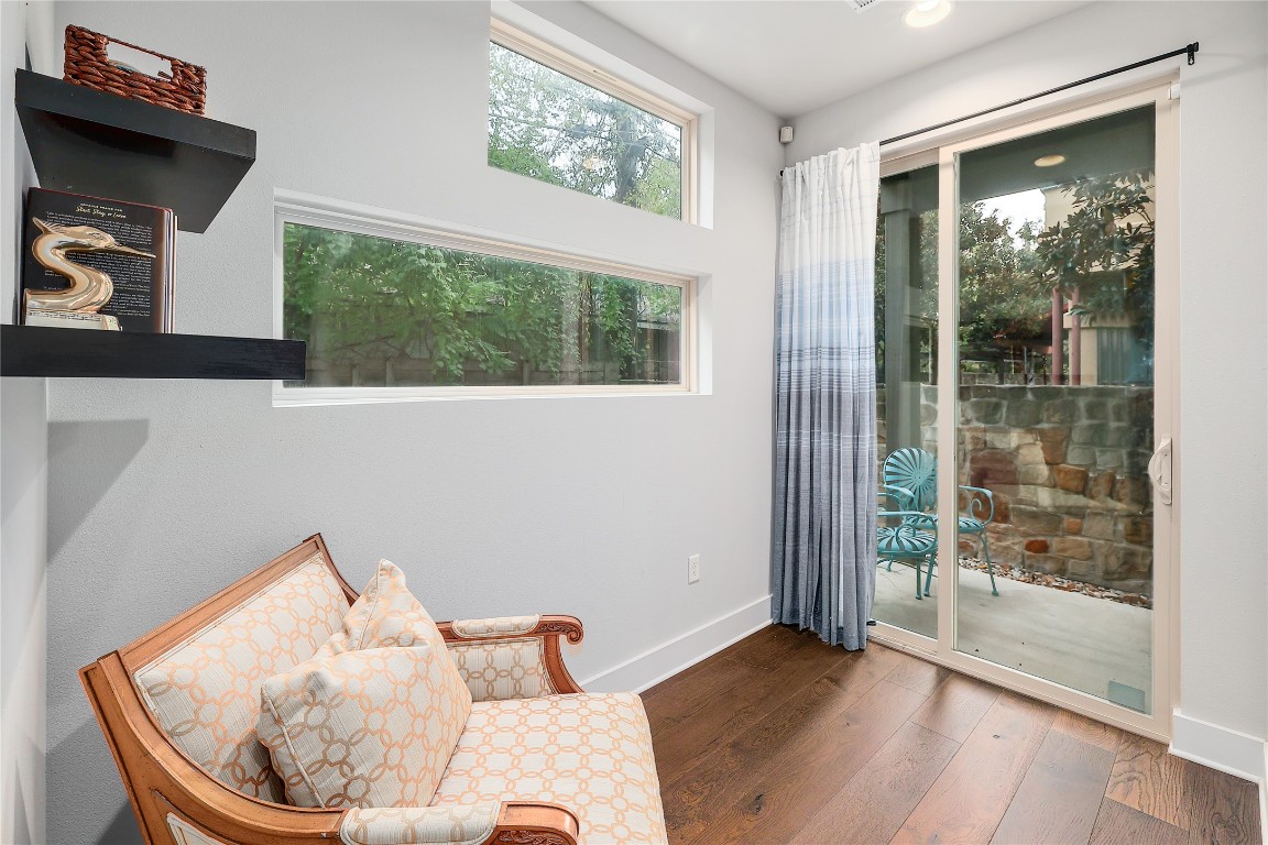 1205 Elm Street, Unit 8 Austin, TX 78703 - Photo 23 of 26 Sitting area downstairs with access to the patio and plenty of natural light.