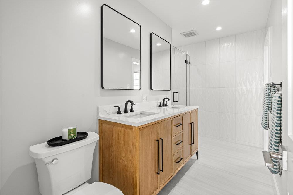 418 Imperial Drive Pacifica, CA 94044 - Photo 34 of 70 a bathroom with a double vanity sink and a toilet