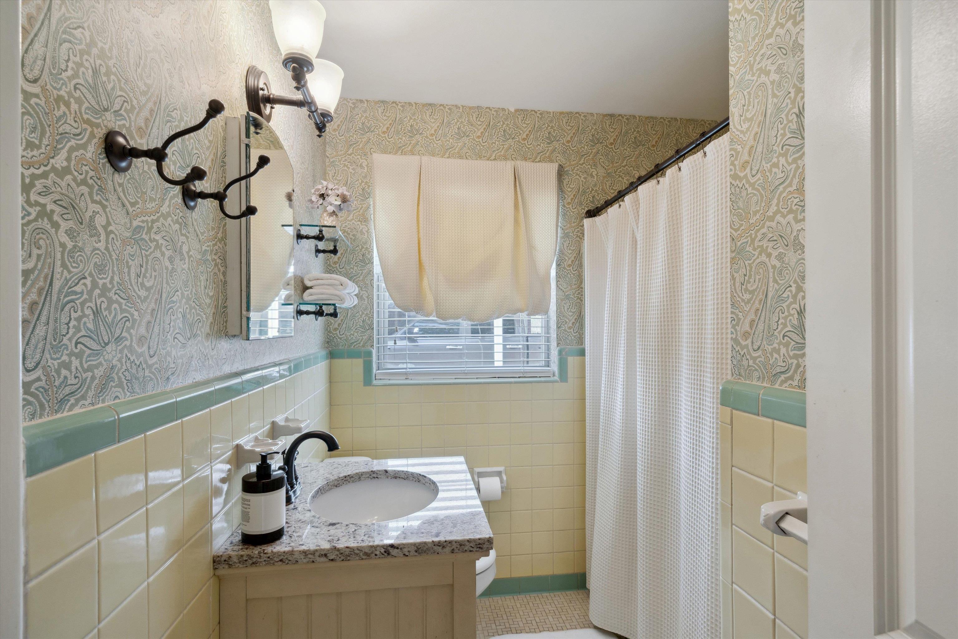 4821 Dee Road Memphis, TN 38117 - Photo 15 of 25 a bathroom with a granite countertop sink a mirror and shower