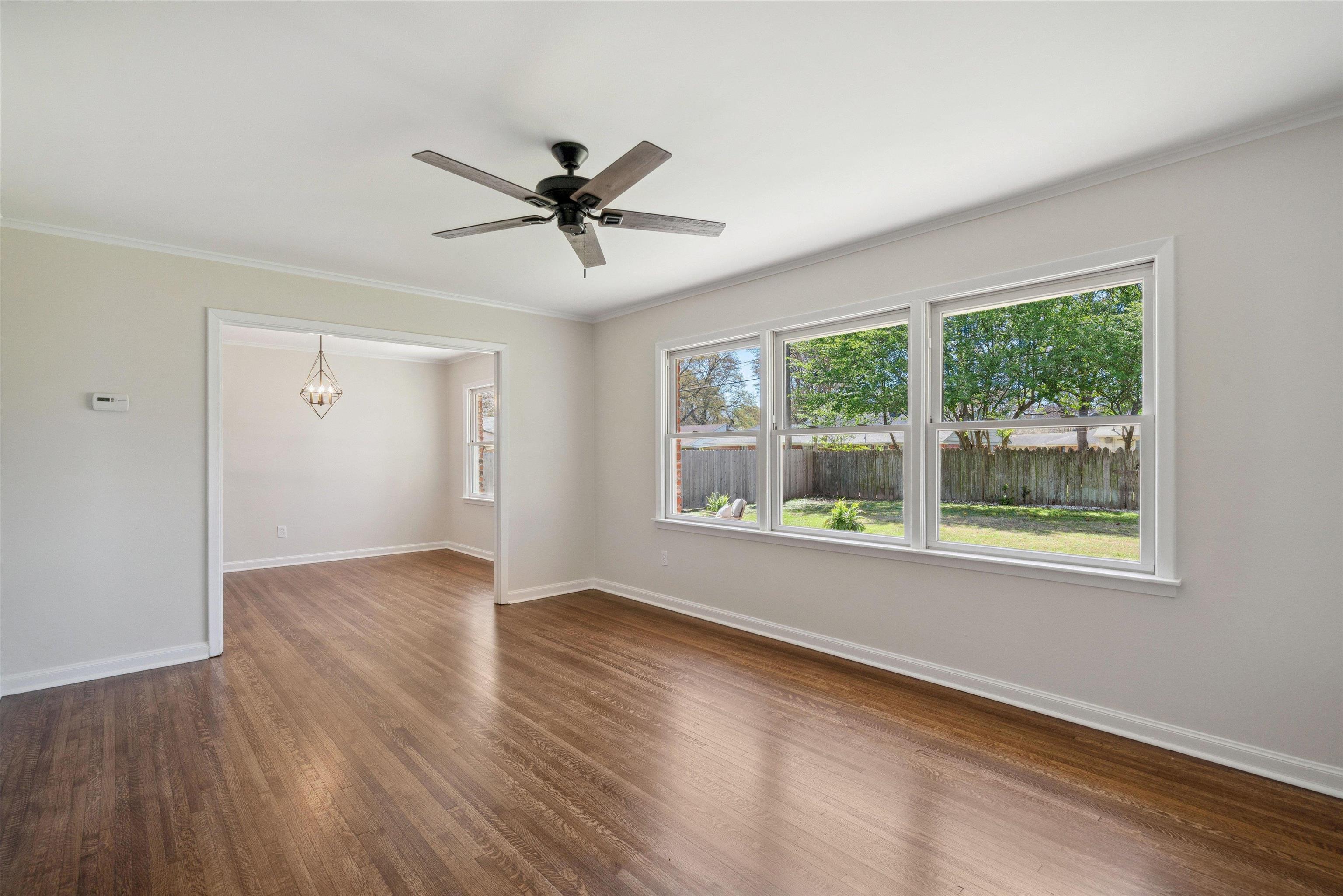 4821 Dee Road Memphis, TN 38117 - Photo 5 of 25 a view of empty room with wooden floor and fan