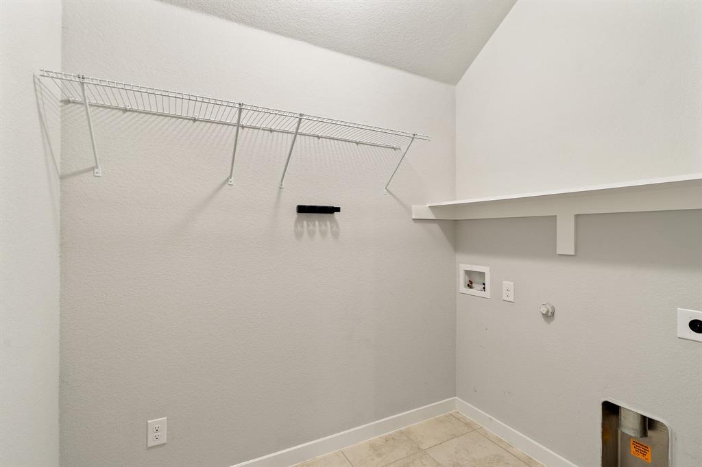 1401 Macaw Court Little Elm, TX 75068 - Photo 18 of 25 Laundry area with hookup for a washing machine, hookup for a gas dryer, light tile patterned floors, hookup for an electric dryer, and a textured ceiling