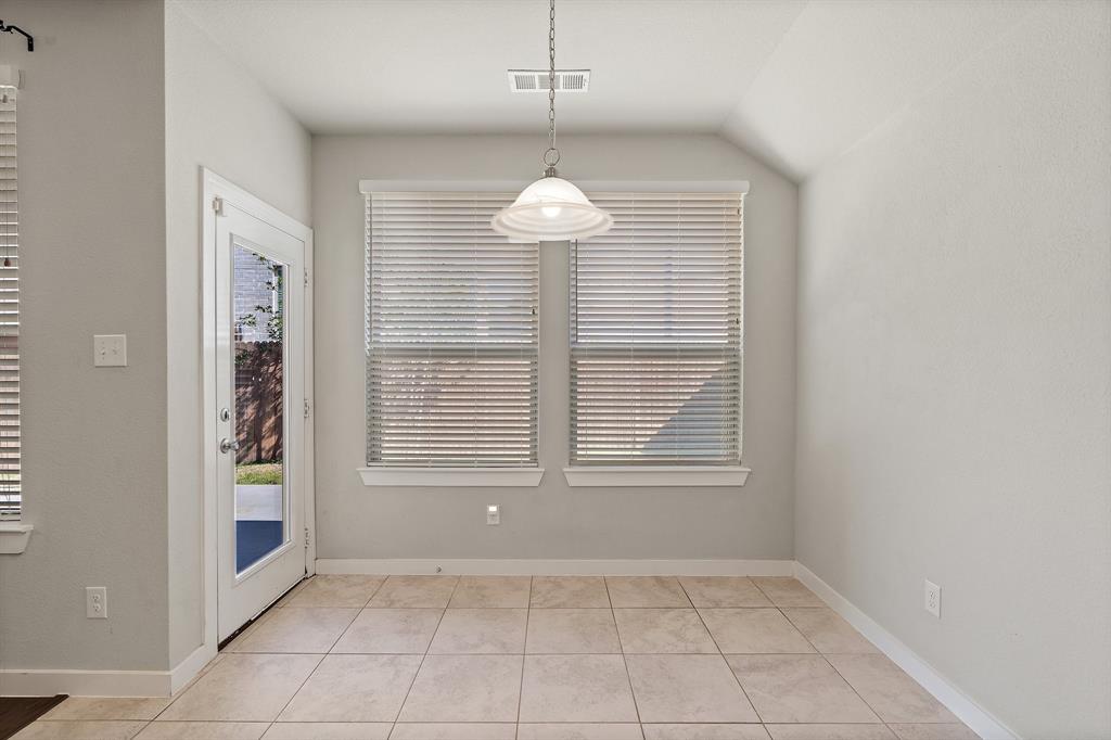 1401 Macaw Court Little Elm, TX 75068 - Photo 19 of 25 Unfurnished dining area with light tile patterned floors and baseboards