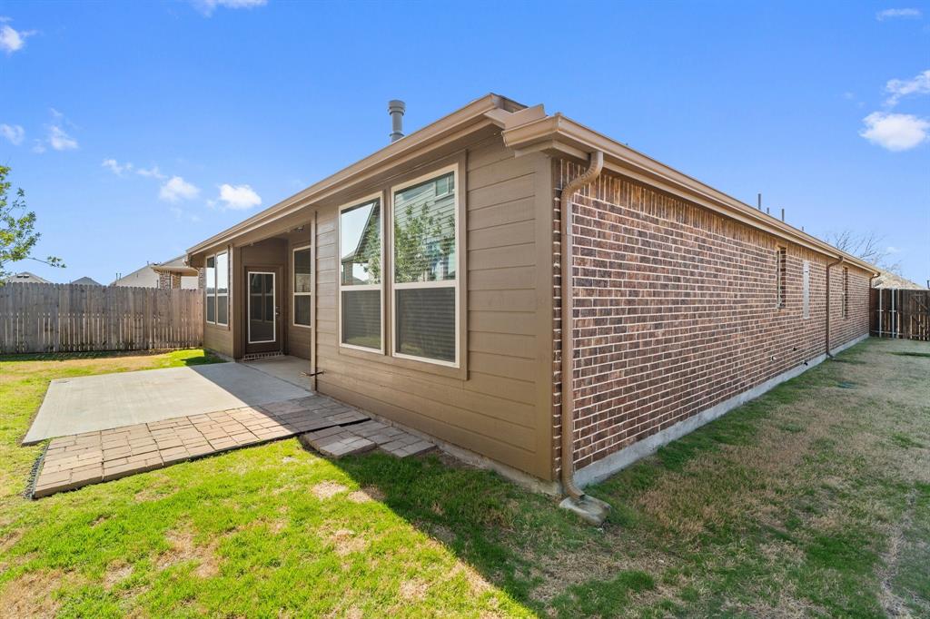 1401 Macaw Court Little Elm, TX 75068 - Photo 21 of 25 View of home's exterior featuring brick siding and a patio