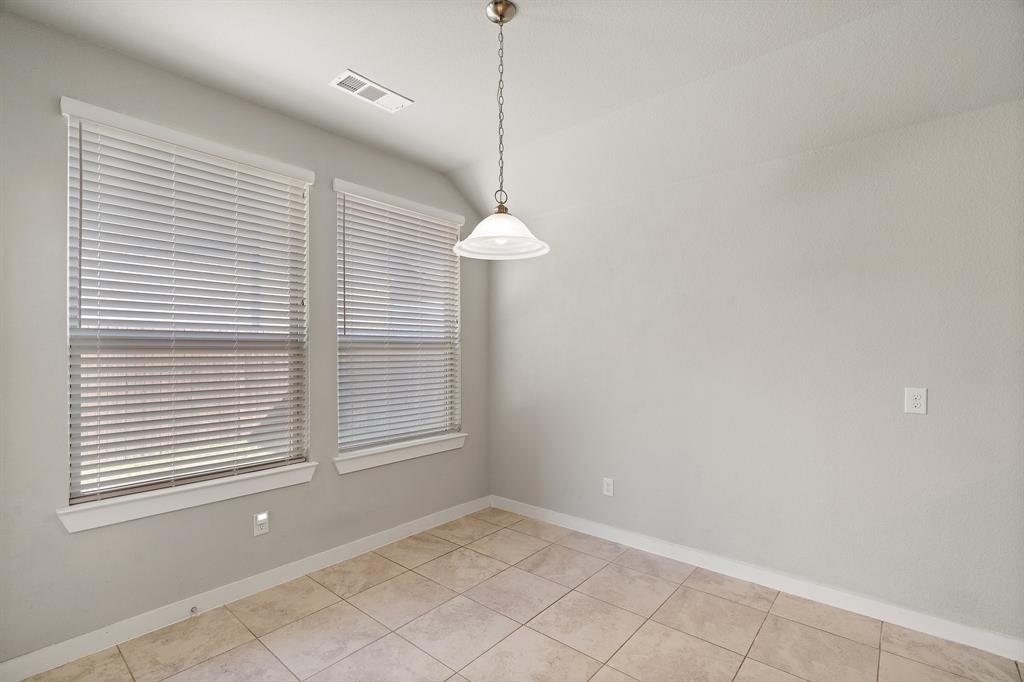 1401 Macaw Court Little Elm, TX 75068 - Photo 4 of 25 Unfurnished dining area with lofted ceiling and light tile patterned floors