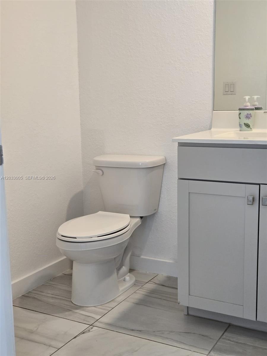 862 Southeast 17 Street, Unit 862 Homestead, FL 33034 - Photo 35 of 39 a white toilet sitting next to a bathroom sink