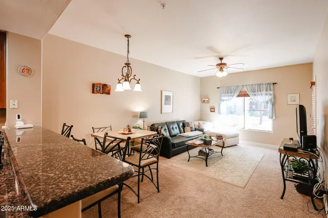 a living room with furniture a flat screen tv and a window